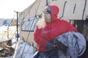 Dotty Agard of the Standing Rock Sioux Tribe helps sort through leftover items at camp.