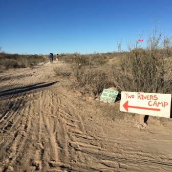 Protesters follow hand-painted signs to the Two Rivers camp in Presidio County, Texas