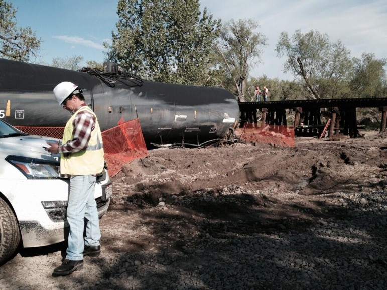 Workers are in the midst of clean-up efforts at the site of a train derailment and crude oil spill located south of Greeley, Colorado on May 12, 2014. 