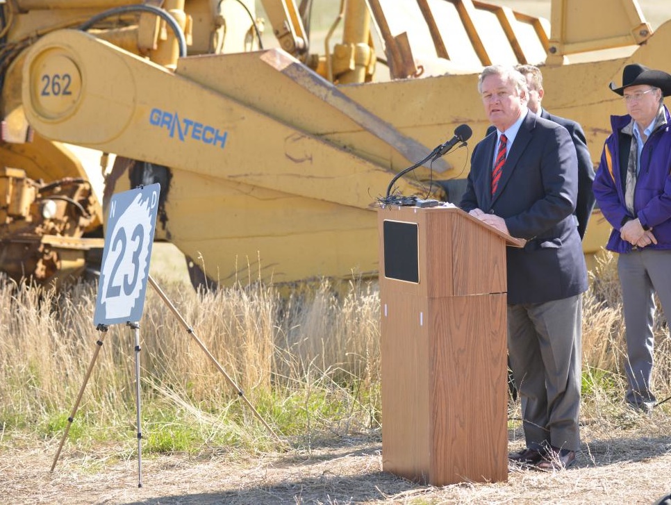 Gov. Jack Dalrymple speaks at the groundbreaking ceremony for the Watford City highway by-pass in May 2014, which will reduce oilfield traffic through town.