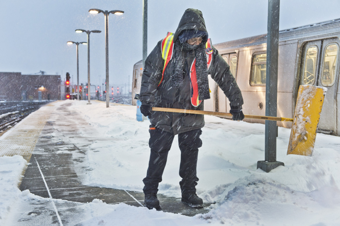 Transit worker clears snow off subway platform during the storm that hit the New York City area on January 21, 2014.