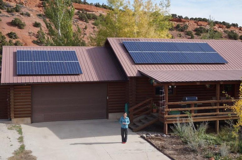 Holly Copeland in front of the family's house and their newly-installed solar array.