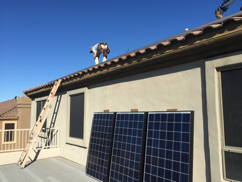 A crew from the Arizona-based solar installer, SunHarvest Solar, put up solar panels on a residence in Scottsdale, Arizona.