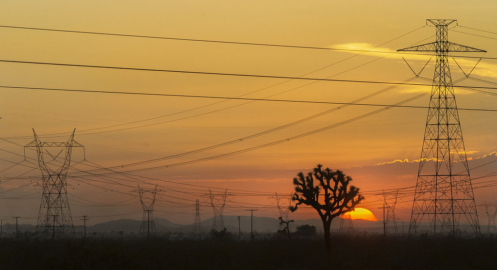 Transmission lines criss-cross the landscape in Adelanto, California. Image via Flickr user jose|huerta shared with a Creative Commons license.