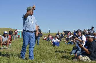 Standing Rock historic preservation officer Jon Eagle Sr. addresses a crowd of protesters gathered at a camp near the Dakota Access Pipeline construction site along the Missouri River.